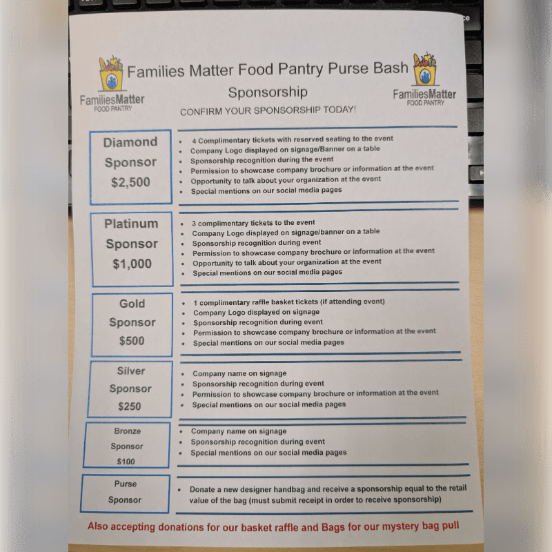 A sponsorship information sheet for a "Families Matter Food Pantry Purse Bash" is laid out on a wooden surface.