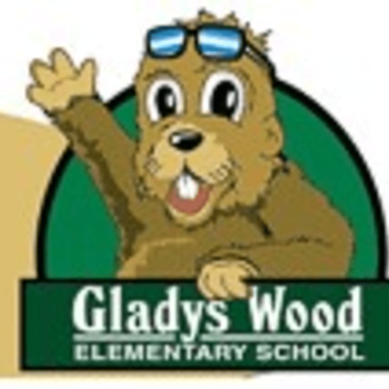 A cartoon beaver wearing sunglasses waves from behind a sign for Gladys Wood Elementary School.