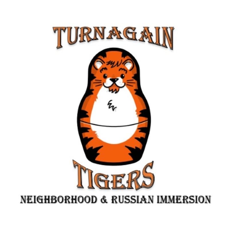 A tiger-striped matryoshka doll with "TURNAGAIN TIGERS" above and "NEIGHBORHOOD & RUSSIAN IMMERSION" below is centered on a white background.
