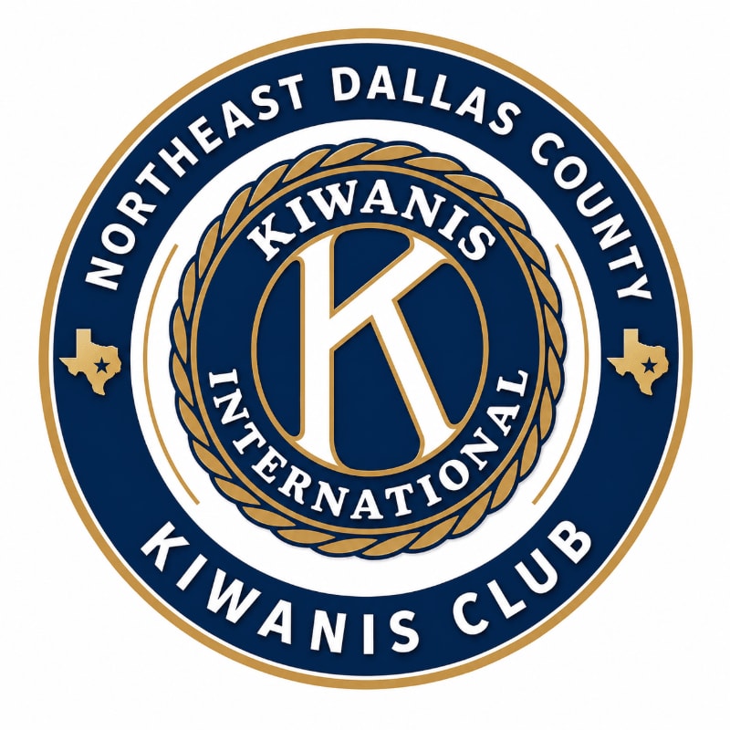 A circular logo with the letters "KIWANIS INTERNATIONAL" and "NORTHEAST DALLAS COUNTY KIWANIS CLUB" encircling a large "K" in the foreground, set against a white background with small Texas star insignias on either side in the background.