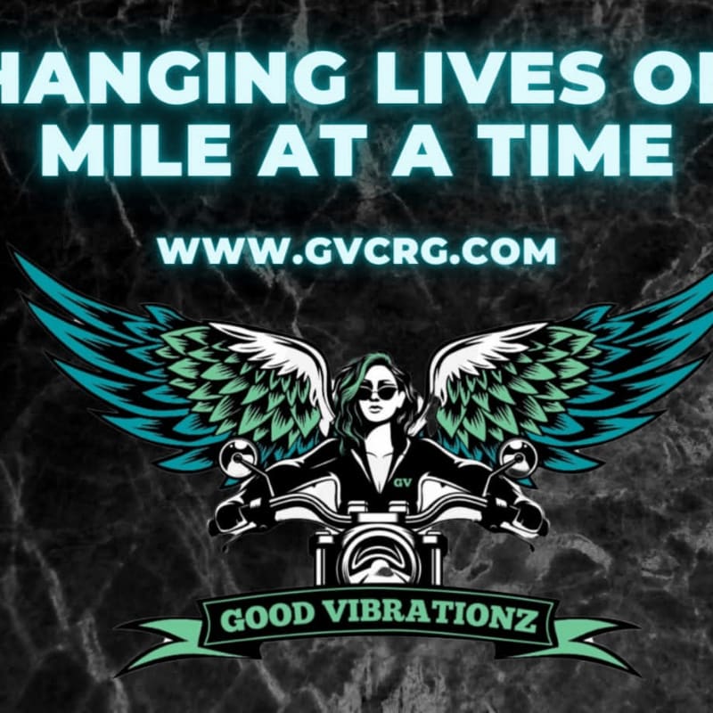 A woman with feathered wings rides a motorcycle in the foreground, with a website and slogan against a dark, marbled background.