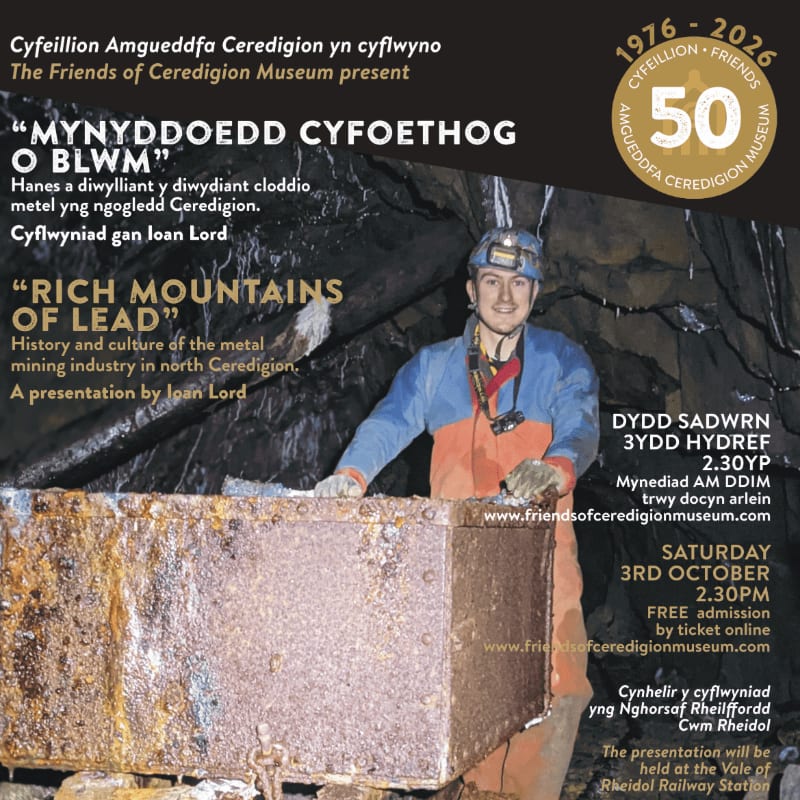 A man in mining gear stands behind a large piece of ore in a dark mine, with event details for a presentation on lead mining in Ceredigion displayed on the right.