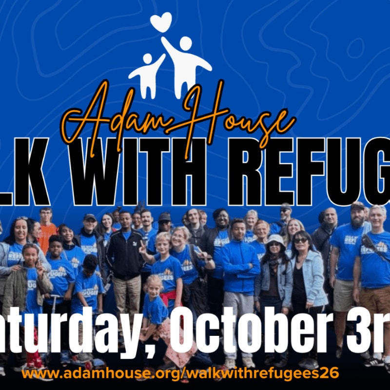 A large group of people, some wearing blue t-shirts, stand together in the foreground with a blue background featuring the "Adam House Walk With Refugees" logo and event details.
