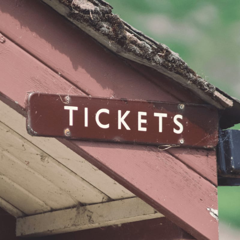 tickets signboard on wooden surface
