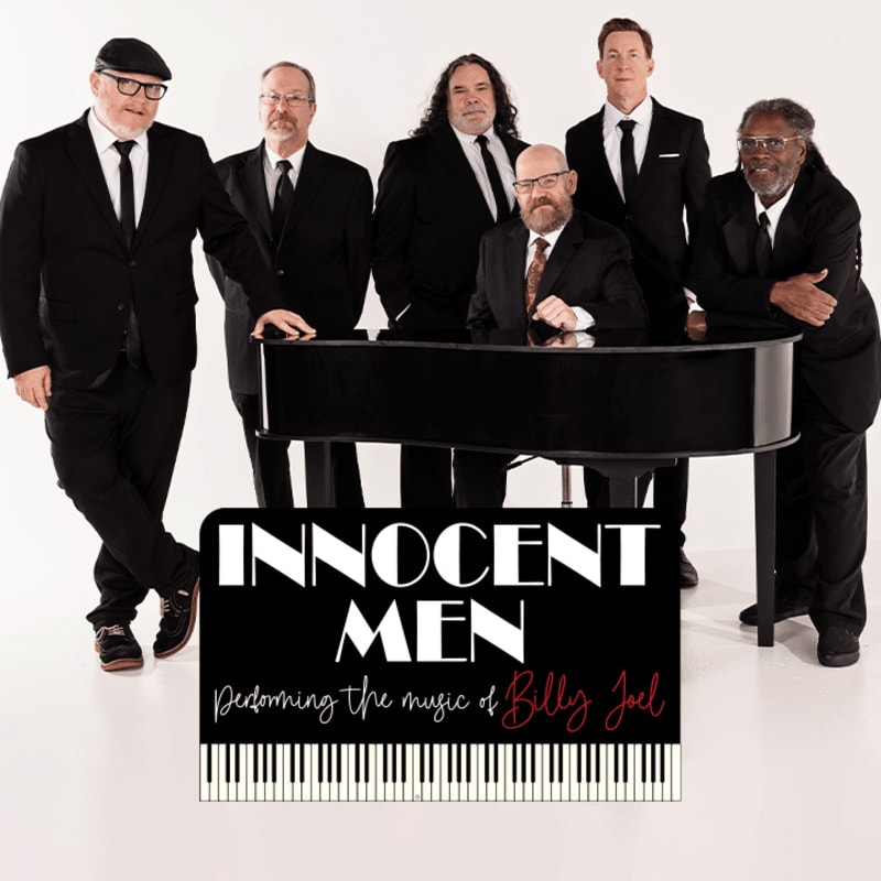 Six men in suits stand behind a grand piano with a sign in front that reads "INNOCENT MEN Performing the music of Billy Joel" against a white background.
