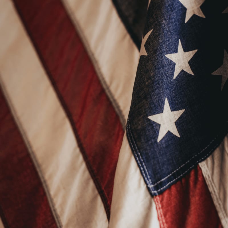 A folded American flag with red and white stripes and white stars