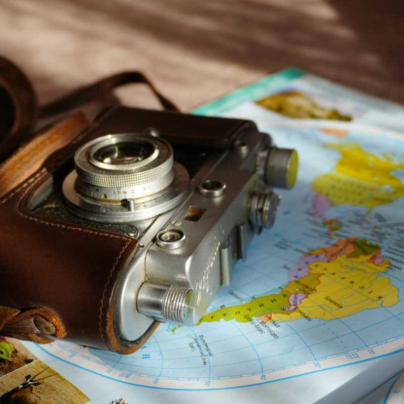 Vintage camera rests on a world map