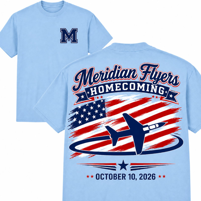 A light blue t-shirt with an "M" on the left chest is shown in the foreground, while the background features the back of another t-shirt with a patriotic design including an American flag, an airplane, and the text "Meridian Flyers Homecoming October 10, 2026".