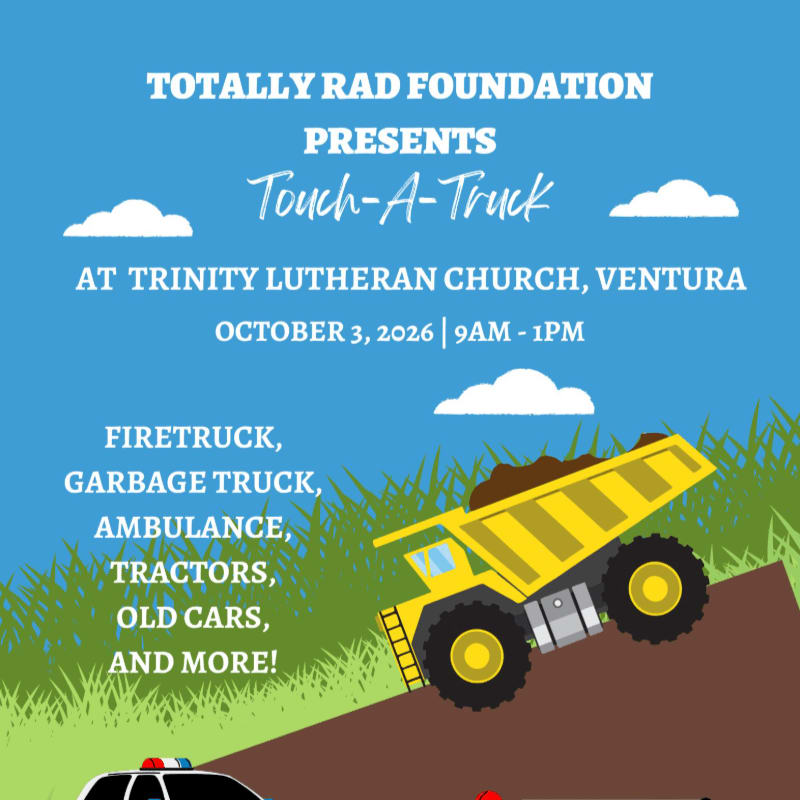 A yellow dump truck and a police car are featured in the foreground against a blue sky with clouds and green grassy hills in the background, advertising a "Touch-A-Truck" event.