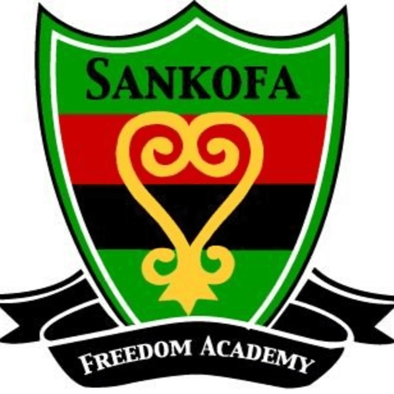 A shield-shaped crest with the word "SANKOFA" at the top and a stylized golden symbol in the center, set against a background of red, black, and green stripes, is displayed above a black banner with "FREEDOM ACADEMY" written on it.
