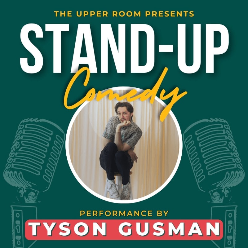 A man sits on a stool in front of a curtain, framed by two vintage microphones and the words "STAND-UP Comedy" and "TYSON GUSMAN" on a teal background.