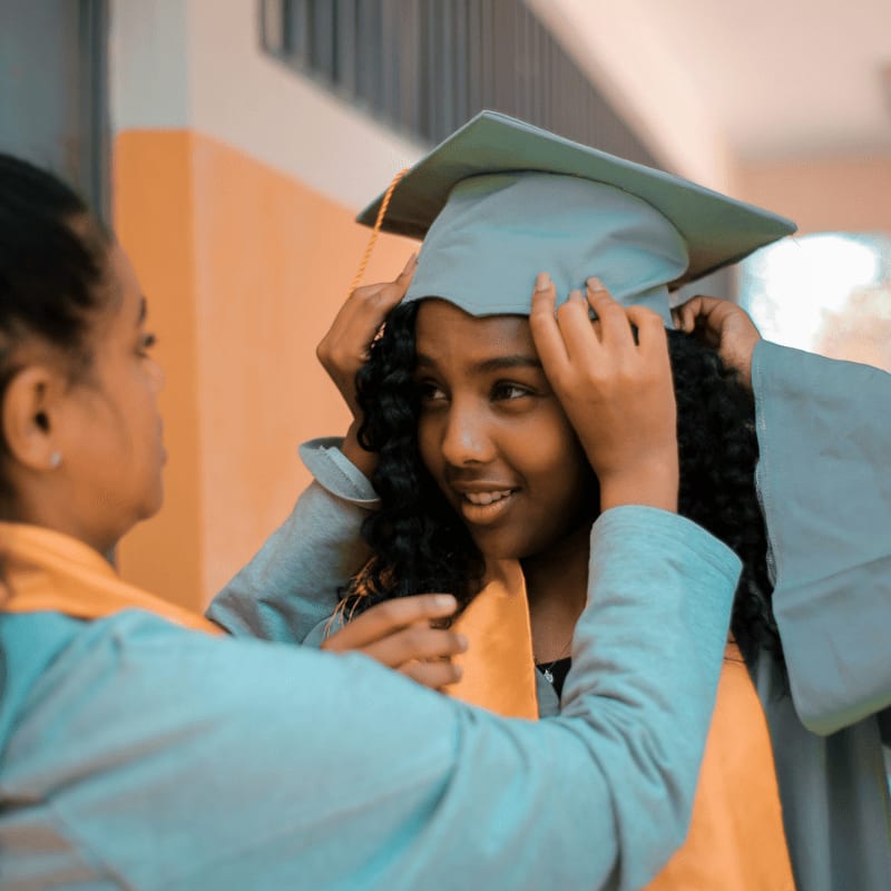 selective focus photography of woman wearing gray academic dress