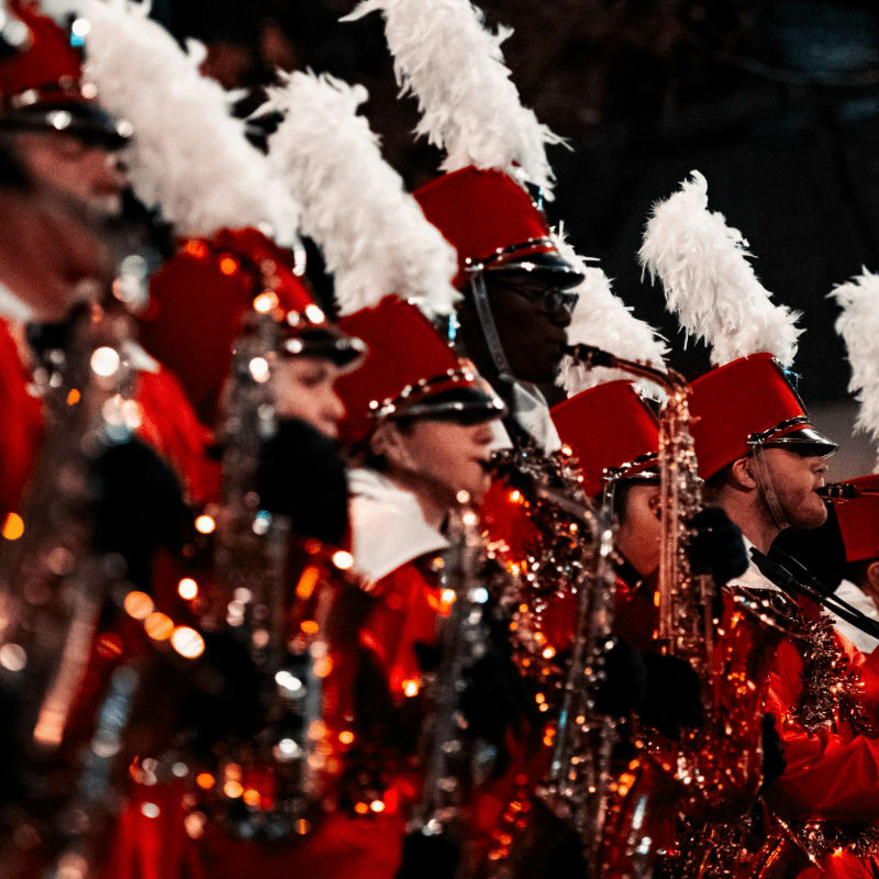 a group of people in red and white costumes