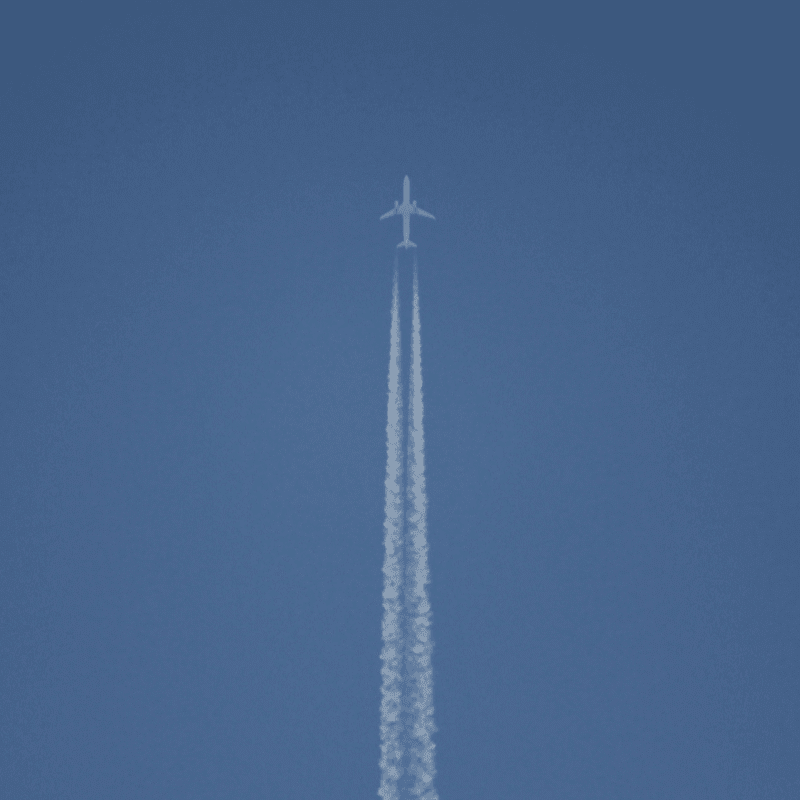 white wind turbine under blue sky