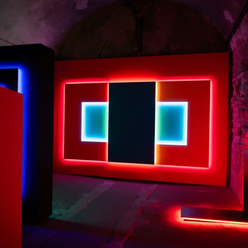 Modern art installation with red and blue neon lights