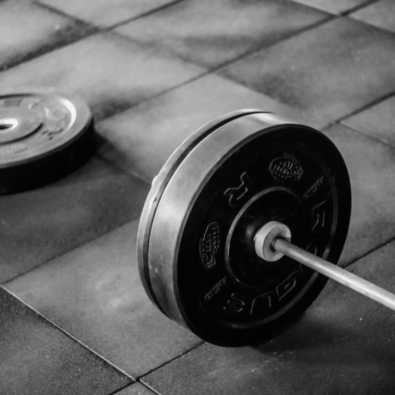 black barbell on tile flooring