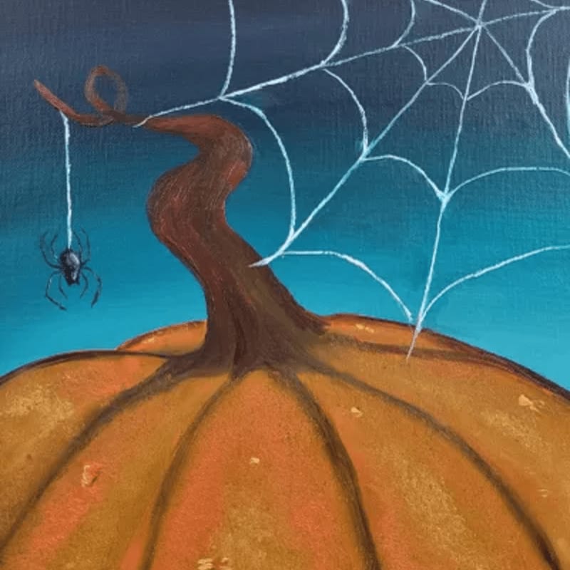 A small spider hangs from a web attached to a pumpkin stem against a dark blue background.
