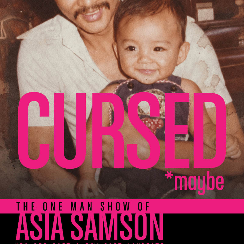 A smiling baby is held by a man in the foreground, with the word "CURSED" in large pink letters overlaying them, and a black bar at the bottom with text about "THE ONE MAN SHOW OF ASIA SAMSON".