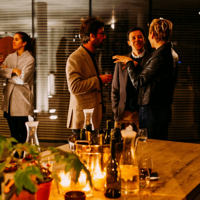 five person standing while talking each other
