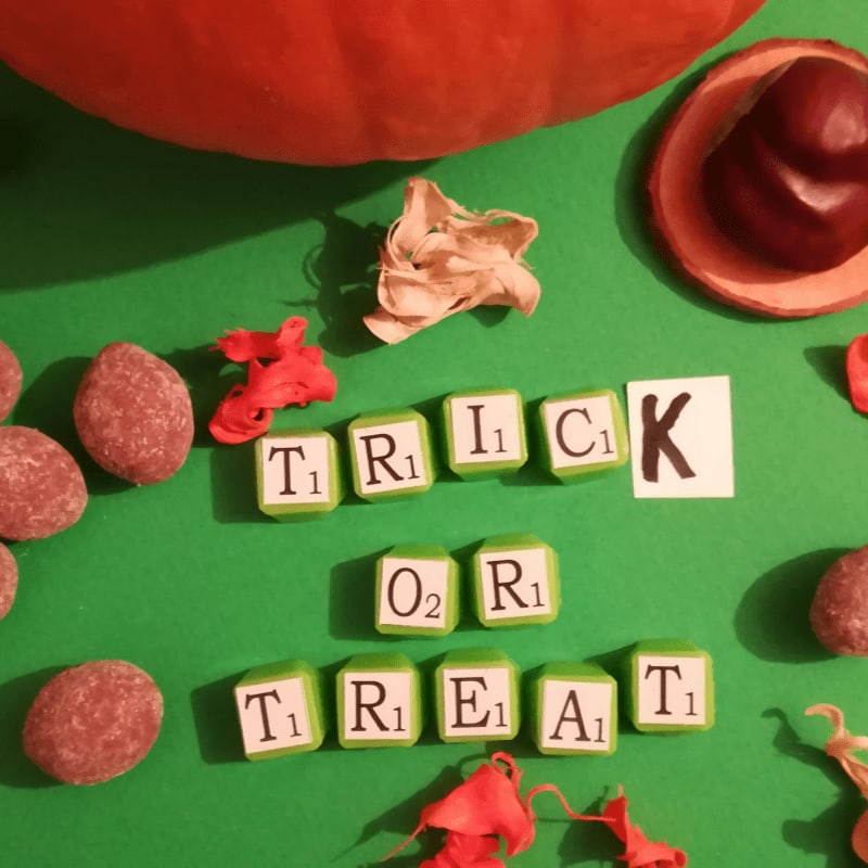 a green table topped with scrabbles and candy