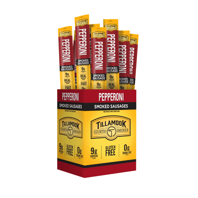A box of Tillamook Pepperoni Smoked Sausages stands in the foreground, with individual pepperoni sticks peeking out from the top against a white background.