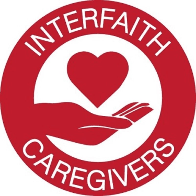 A red circle with white text "INTERFAITH CAREGIVERS" surrounds a white circle containing a red heart above an open hand.
