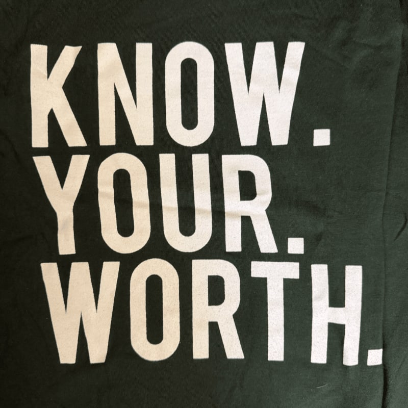 White text reading "KNOW. YOUR. WORTH." is printed on a dark green background.