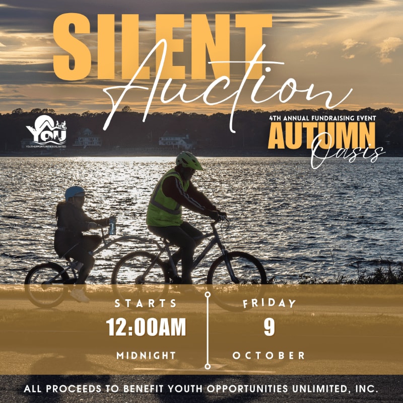 Two people cycle along a waterfront path in the foreground, with a serene sunset over the water and distant houses in the background, all overlaid with text announcing a silent auction.