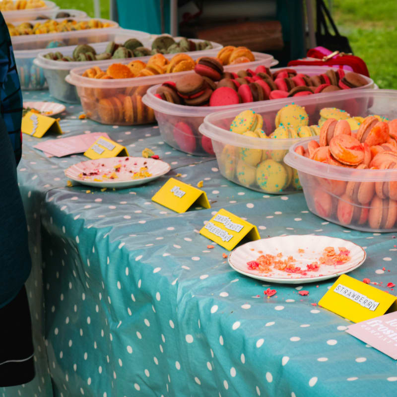 a table topped with plastic containers filled with food