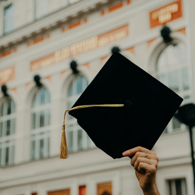person holding black academic hat