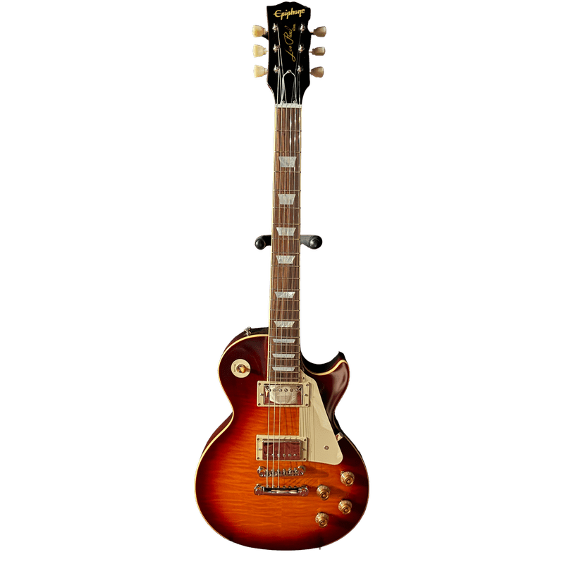 A sunburst electric guitar stands on a black stand against a plain white background.