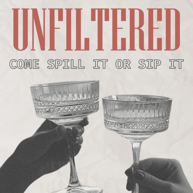 Two hands hold up ornate champagne coupes in the foreground against a textured background with the words "UNFILTERED" and "COME SPILL IT OR SIP IT" in large text.