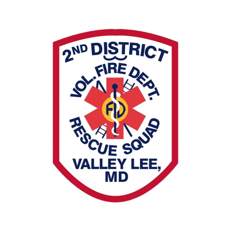 A red and white shield with "2ND DISTRICT VOL. FIRE DEPT. RESCUE SQUAD VALLEY LEE, MD" written in blue and red text, featuring a red star with a medical caduceus in the center, is set against a plain white background.