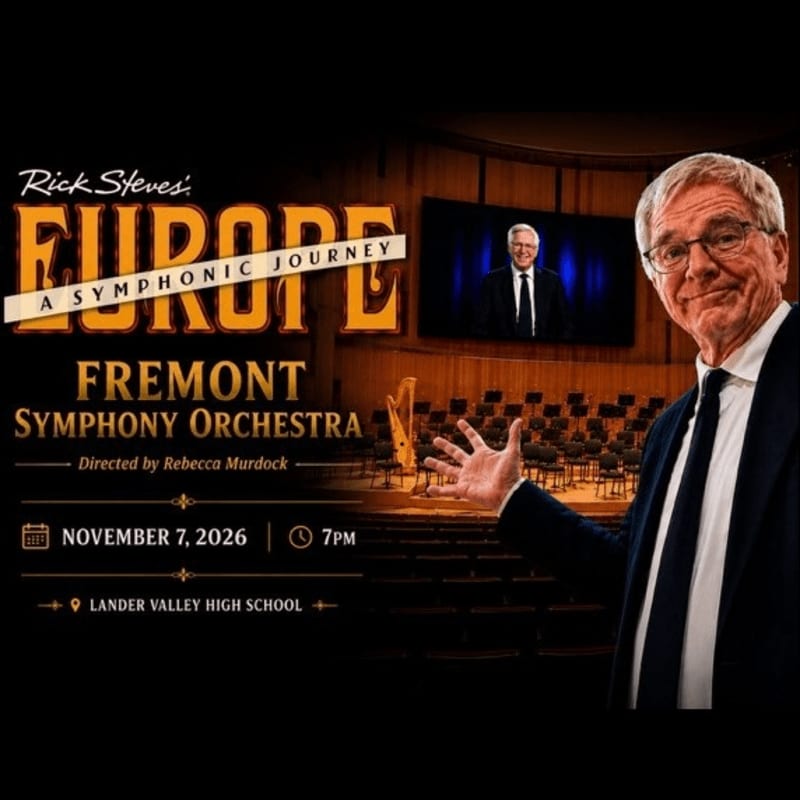 Rick Steves gestures towards a screen displaying him in front of an empty concert hall, advertising the Fremont Symphony Orchestra's "Europe: A Symphonic Journey" on November 7, 2026, at Lander Valley High School.