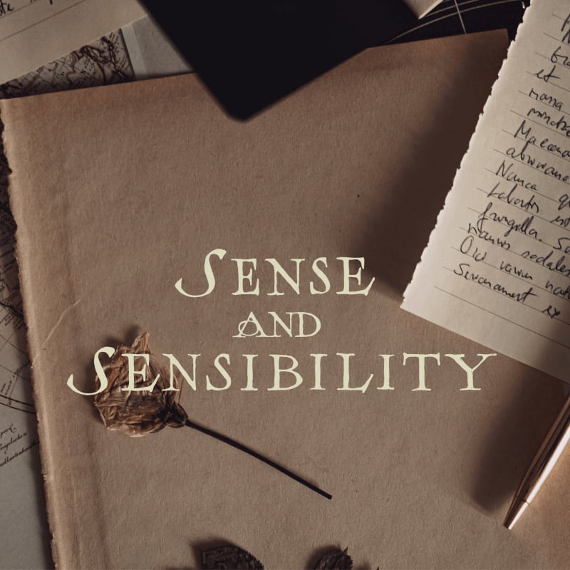 A dried leaf rests on a book titled "Sense and Sensibility" in the foreground, with handwritten notes and a pen in the background.