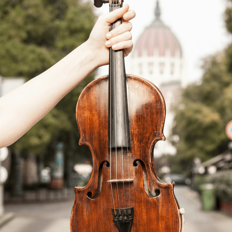 person playing violin during daytime