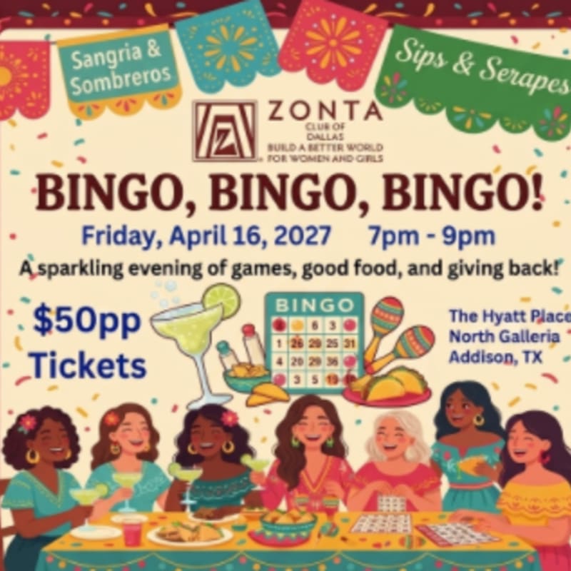 A group of smiling women enjoy drinks and bingo at a festive event with colorful decorations in the background.