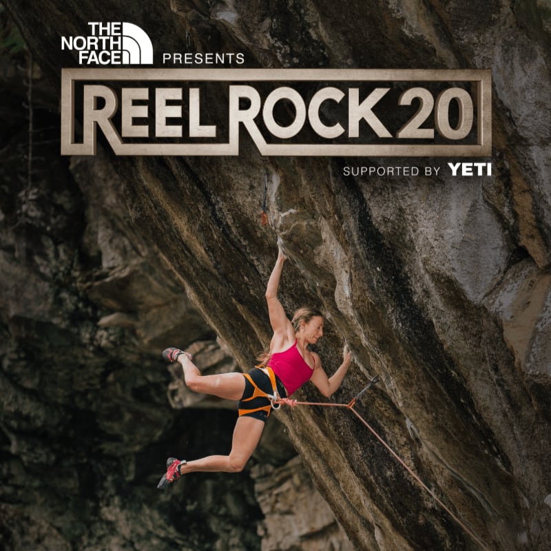 A female rock climber hangs precariously from a sheer cliff face in the foreground, with the "Reel Rock 20" logo prominently displayed in the background.