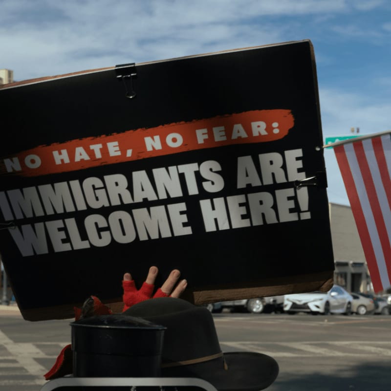Protest sign reads immigrants are welcome here
