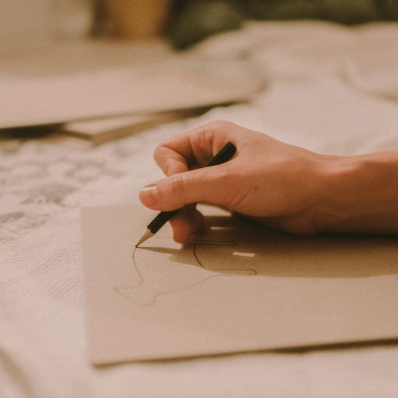 person writing on white paper