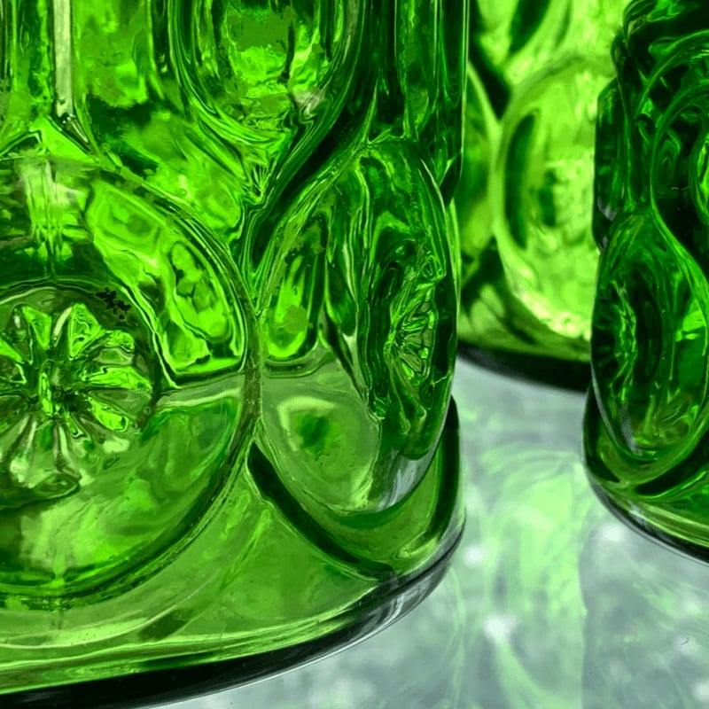 a close up of a green glass vase