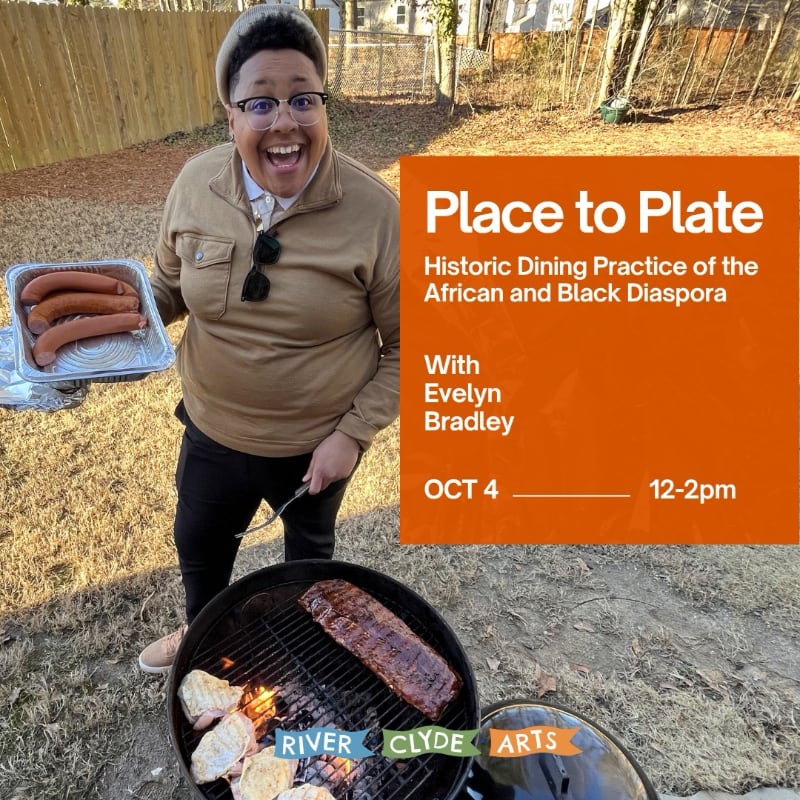 A person with a wide smile holds a tray of sausages over a grill with ribs and chicken, set against a blurred background of a backyard fence and trees.