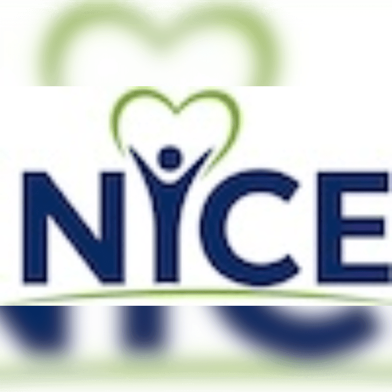 A dark blue logo with a stylized heart and person above the letters "NYCE" is set against a blurred green and white background.