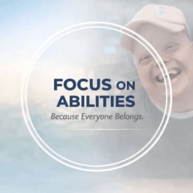 A smiling person wearing a pink cap is in the background, while the foreground features a circle with the text "FOCUS ON ABILITIES Because Everyone Belongs."