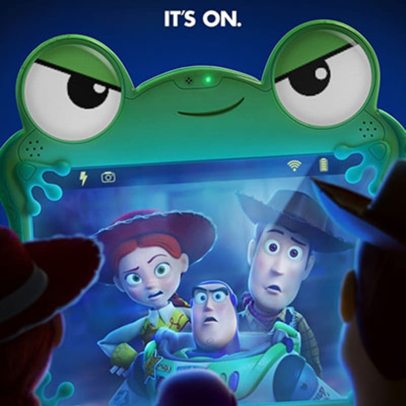 In the foreground, Woody and Buzz Lightyear look concerned as Jessie peeks over Buzz's shoulder, all framed by a frog-shaped tablet screen, while the background displays the text "IT'S ON."