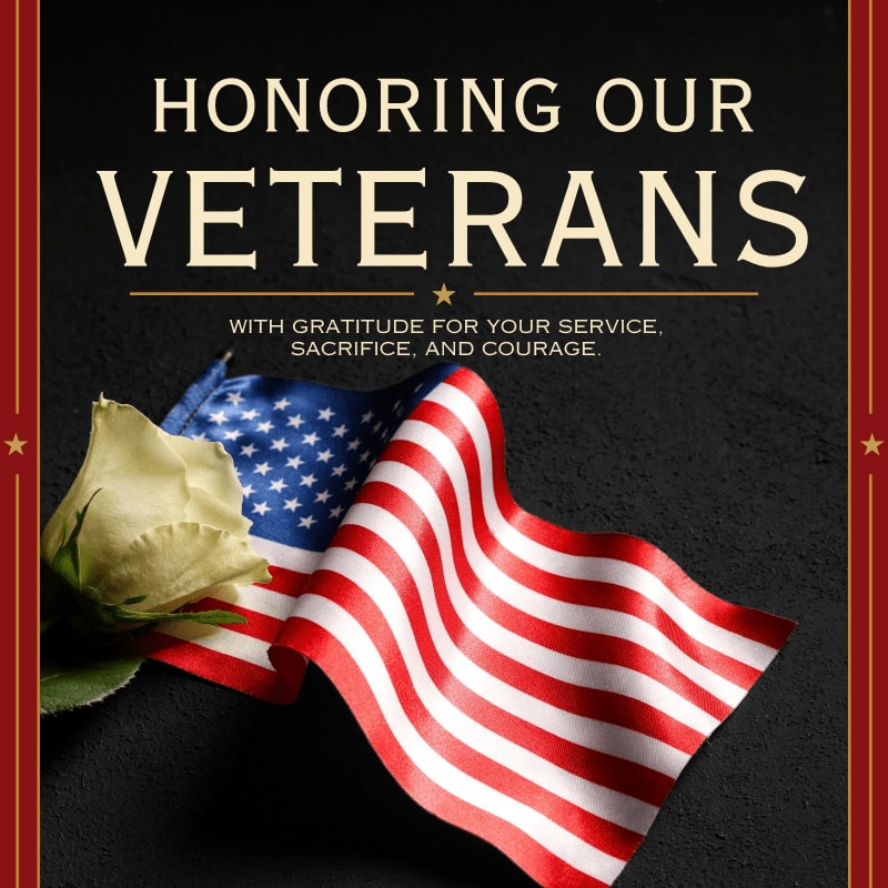 A white rose rests on a waving American flag in the foreground, set against a dark background with text honoring veterans.