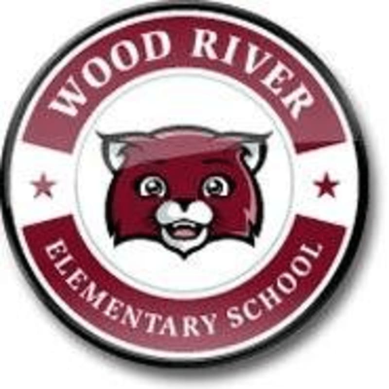 A cartoon red panda mascot with the words "WOOD RIVER ELEMENTARY SCHOOL" encircling it is set against a white background within a circular emblem.
