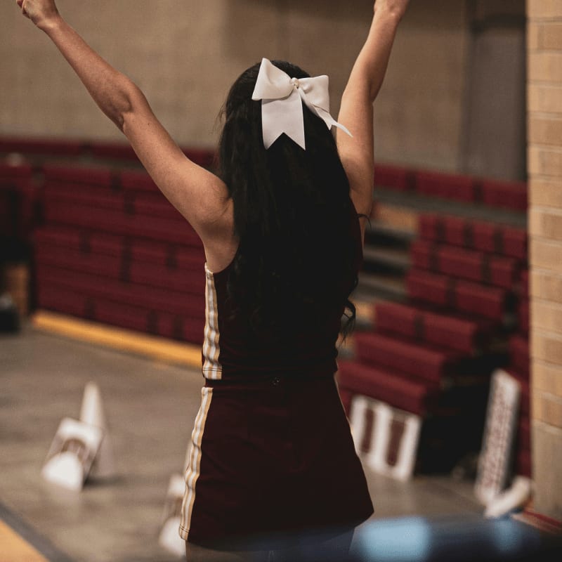 a woman with her arms in the air in a gym