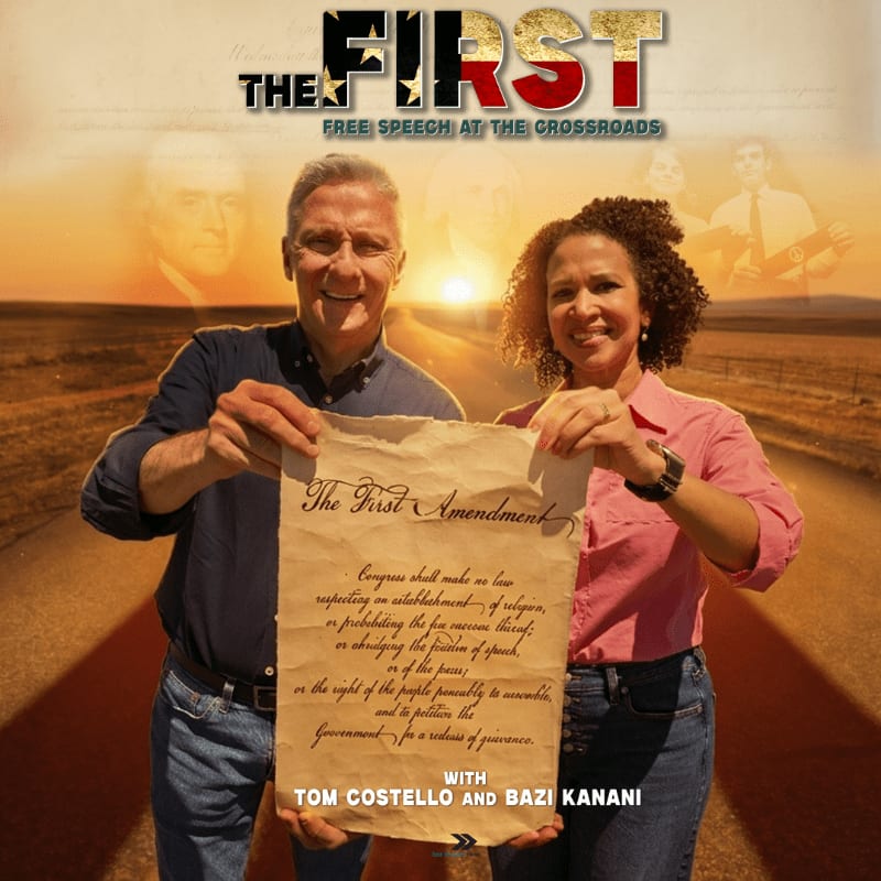 A man and woman hold up a replica of the First Amendment in the foreground, with a sunset over a rural landscape and historical figures in the background.