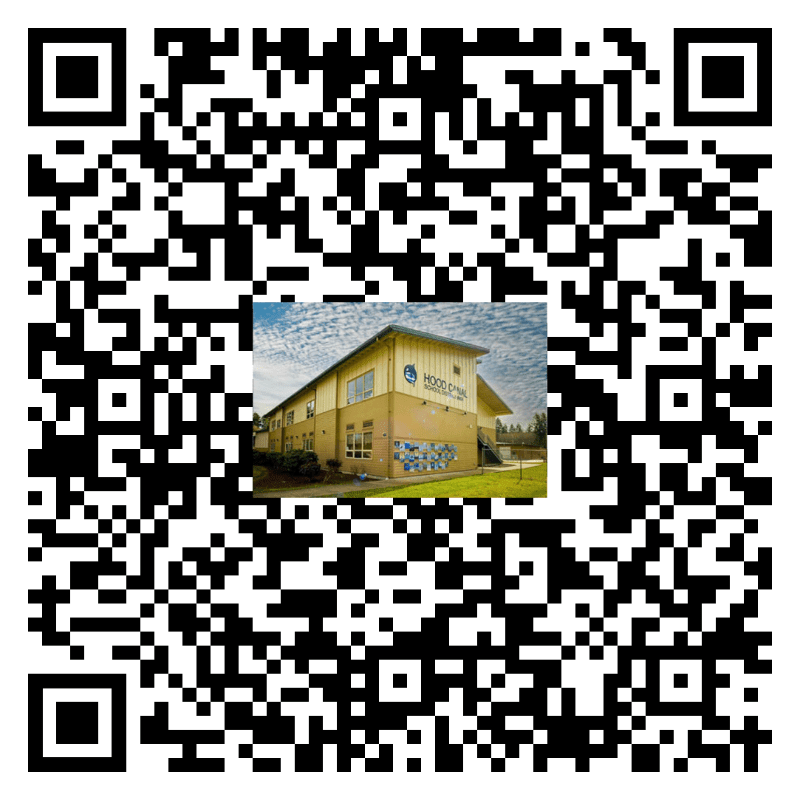 A QR code fills the frame, with a small image of a yellow building with a mural on its side and trees in the background centered within it.